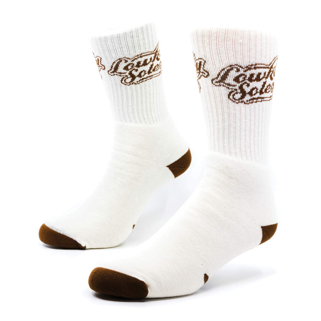 a pair of white socks with brown features on the ribbing, heel, and toe