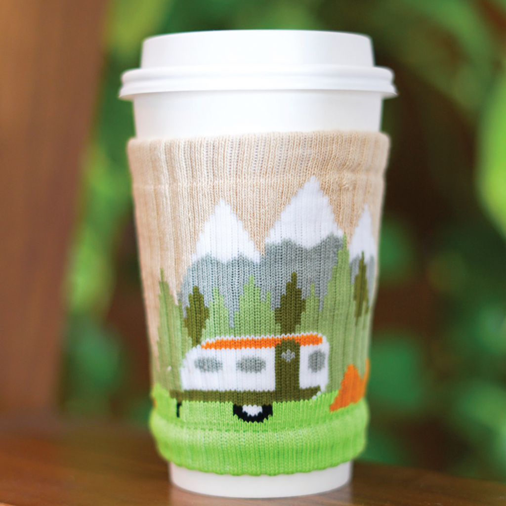 A to-go coffee cup covered with a knitted drink sleeve