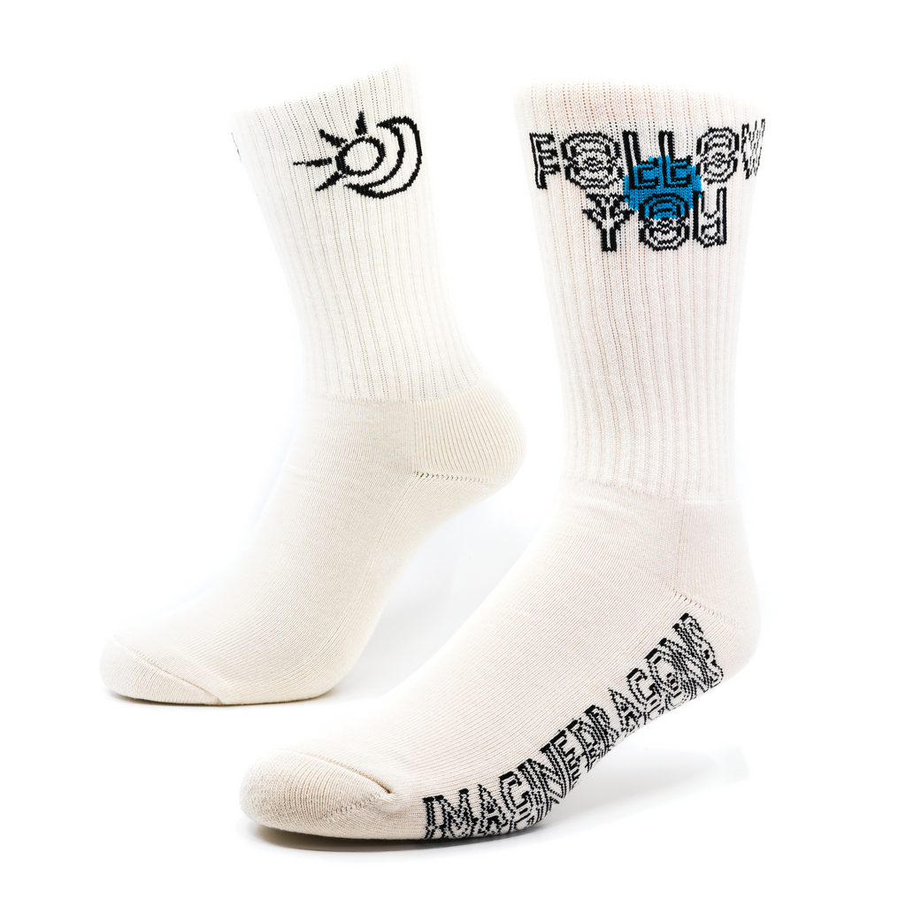 a pair of light tan socks with Image Dragons and other symbols knitting onto the sock