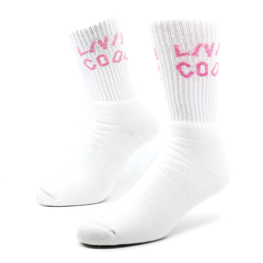 a pair of white socks with pink lettering knitted into the ribbing of the sock