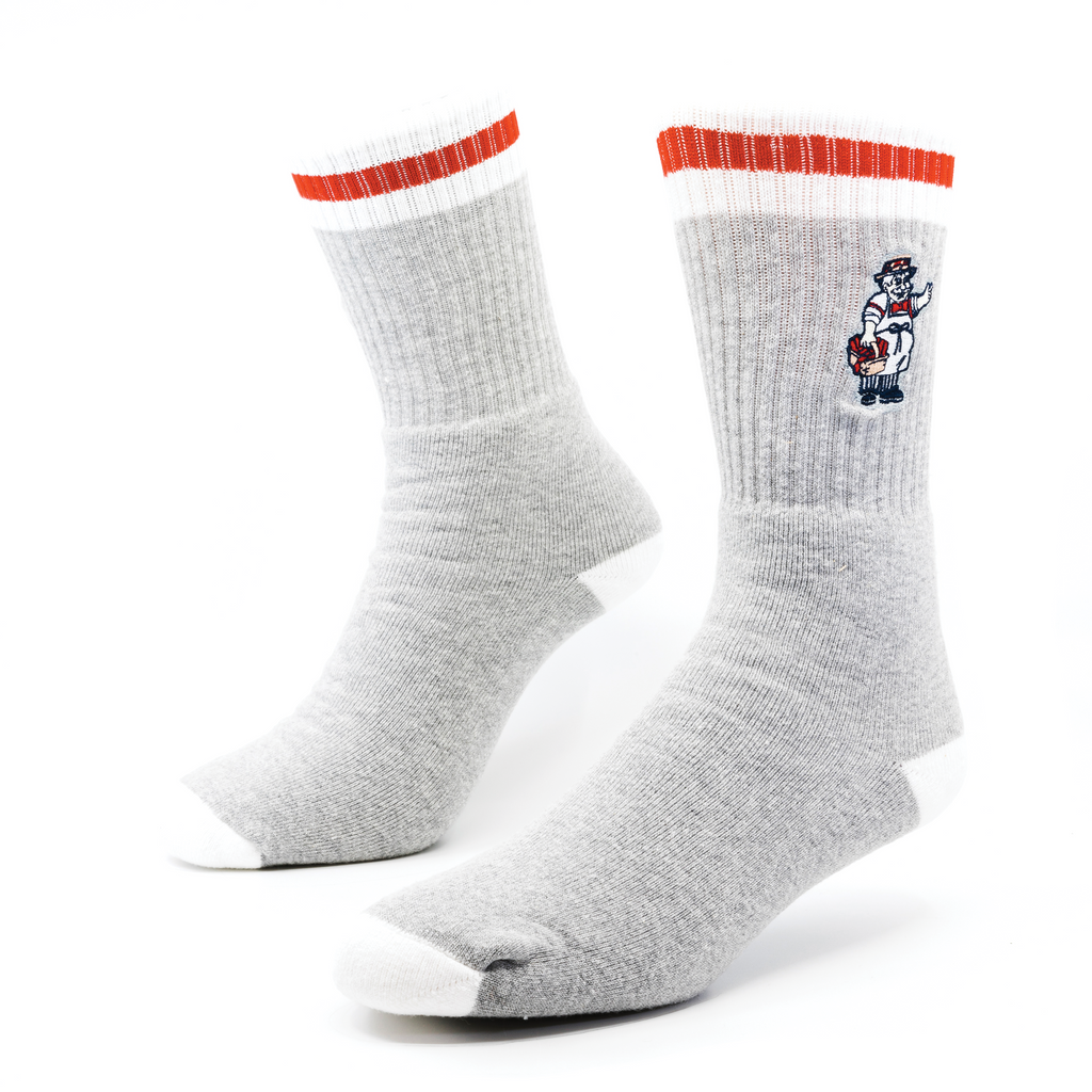 A pair of custom-knit striped socks with an embroidered figure on the body of the sock